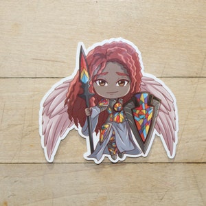 May include: A sticker of a cartoon angel with pink wings, red hair, and a colorful stained glass shield and spear. The angel is wearing a grey and colorful outfit.