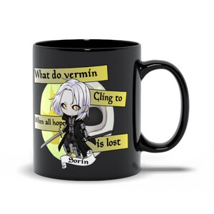 May include: Black coffee mug with a white character illustration and text that reads "What do vermin cling to when all hope is lost? Sorin".