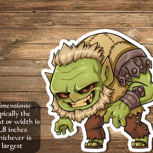 May include: A green cartoon goblin with a grumpy expression, wearing a brown shirt and pants, and a metal arm guard. The goblin is standing on a wooden background. Dimensions: typically the height or width is 2.8 inches whichever is largest.