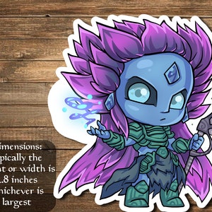 May include: A sticker featuring a cartoon illustration of a blue-skinned female character with purple hair, wearing green armor and holding a spear. The character has a large, crystal-like gem on her forehead. The sticker is approximately 2.8 inches in size.