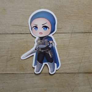 May include: A blue and white chibi-style sticker of a female character with a sword. She is wearing a blue hooded tunic, armour, and boots.