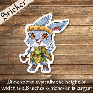 May include: A sticker of a cute, cartoon bunny wearing a flower crown and a green and yellow outfit. The bunny is holding a pipe in its right paw and has a happy expression on its face.