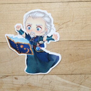 May include: A sticker of a cartoon wizard with a white beard and blue robes, holding a book with a crescent moon and stars on the cover.