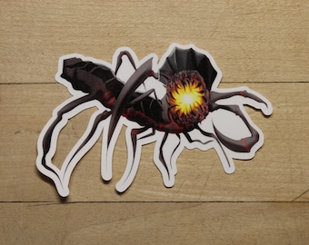 May include: A black and red sticker of a creature with a glowing orange center and multiple legs.