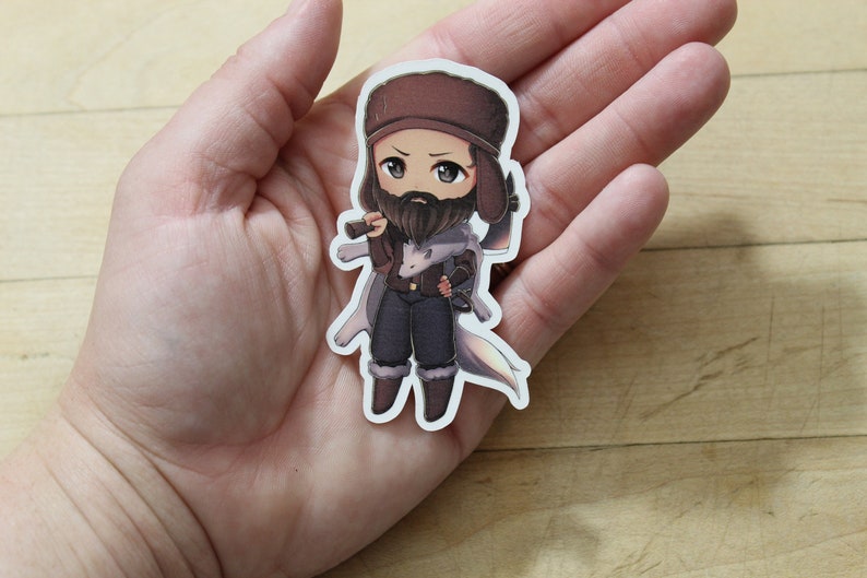May include: A cartoon sticker of a person wearing a brown hat and a white coat, holding a gun and a knife. The person has a beard and is looking to the right.