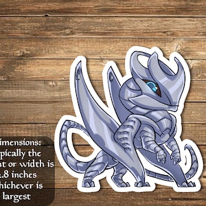 May include: A silver-colored, cartoon-style dragon with blue eyes. The dragon is standing on all fours with its wings spread out. The dragon is 2.8 inches tall or wide, whichever is largest.