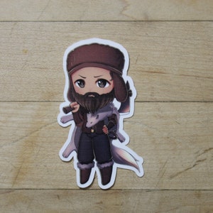 May include: A cartoon sticker of a person with a brown beard and a brown hat holding an axe. The person is wearing a brown jacket, blue pants, and brown boots. The sticker is on a wooden surface.