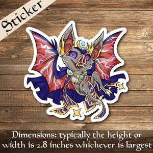 May include: A sticker featuring a cartoon bat with purple eyes, wearing a blue and gold cape with lightning bolt patterns. The bat has a crown and a crescent moon on its head. The sticker is approximately 2.8 inches wide.