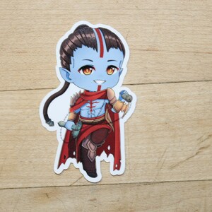 May include: A blue and red anime-style character with long dark hair, wearing a red and gold outfit, holding a weapon in each hand. The character is standing on a wooden surface.