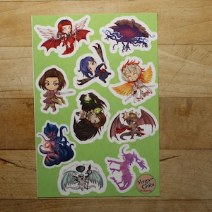 May include: A sheet of stickers featuring various characters and creatures in a chibi style. The stickers are on a green background with white borders. The characters include a winged woman, a knight, a dragon, and a monster. The text "Mega-Chibi" is at the bottom of the sheet.