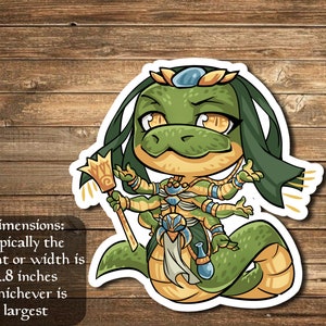 May include: A sticker featuring a cartoon illustration of a green serpent-like creature with multiple arms, wearing gold and blue accents. The sticker is approximately 2.8 inches in height or width. The creature is holding a golden staff.