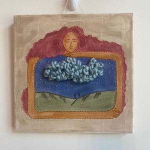 May include: Square canvas art piece featuring a whimsical illustration. A woman's face with red hair is at the top, framing a scene with a blue sky, green hills, and two figures. A fluffy, light blue cloud is in the center.
