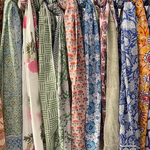 May include: A collection of 10 colorful printed scarves with various patterns and designs. The scarves are made of cotton and are perfect for adding a touch of style to any outfit.