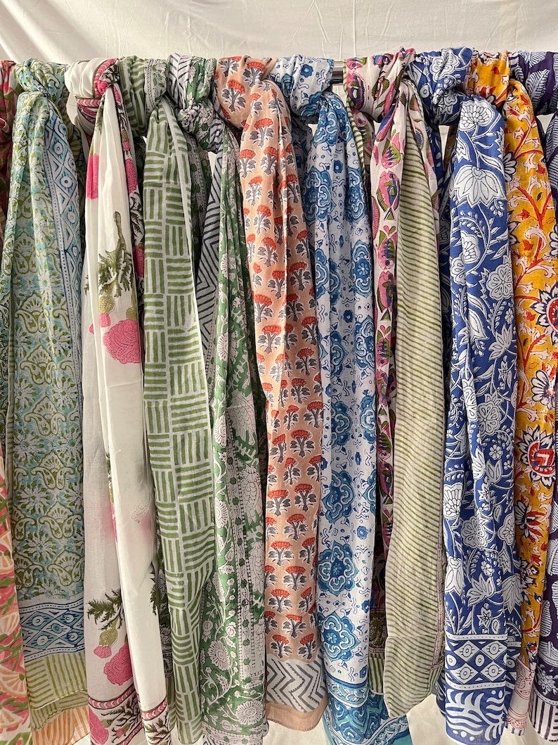 May include: A collection of 10 colorful printed scarves with various patterns and designs. The scarves are made of cotton and are perfect for adding a touch of style to any outfit.