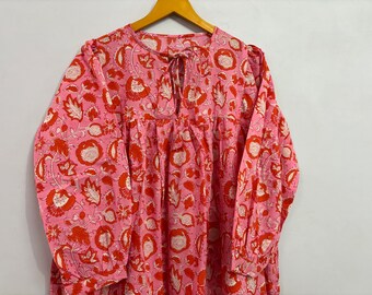 May include: A pink and red floral print long-sleeved dress with a tie neckline.