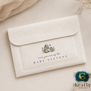 May include: Cream-coloured envelope-style baby announcement with a flap closure. The front features a watercolour illustration of two elephants and the text "our journey to BABY STEVENS".