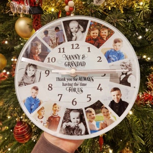 May include: A white round clock with a woodgrain design featuring photos of children and the text "NANNY & GRANDAD" and "Thank you for ALWAYS having the time FOR US".
