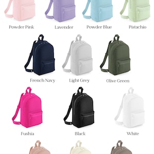 a bunch of different colored backpacks on a white background
