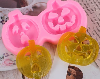 May include: Pink silicone mold with three pumpkin shapes. The mold is designed to create Halloween-themed treats.