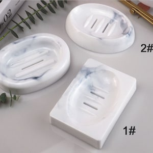 May include: Three white marble soap dishes with different shapes and drain holes. The dishes are labelled 1#, 2#, and 3#.
