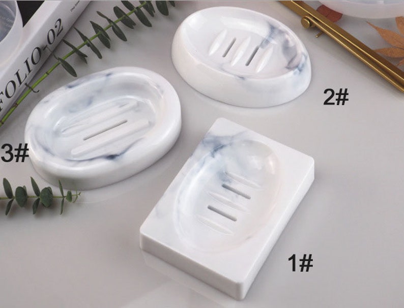 May include: Three white marble soap dishes with different shapes and drain holes. The dishes are labelled 1#, 2#, and 3#.