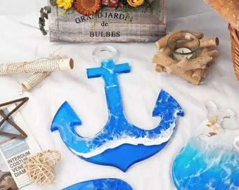 May include: A blue and white resin anchor with a wave design. The anchor is a decorative piece with a nautical theme.