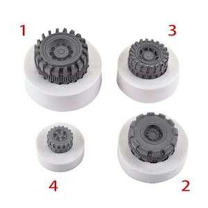 May include: Four white silicone moulds for making cake decorations. The moulds are shaped like different types of tyres. The moulds are numbered 1 through 4.