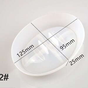 May include: White plastic dish with a raised centre section, measuring 12.5 inches in diameter, 9.5 inches across the centre section, and 2.5 inches in height. The dish is designed for holding and draining small items.