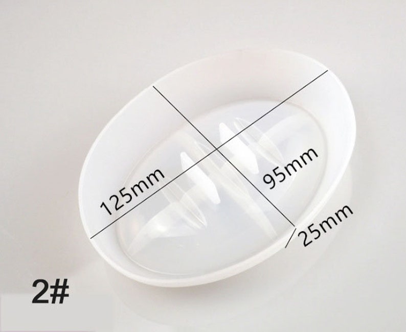 May include: White plastic dish with a raised centre section, measuring 12.5 inches in diameter, 9.5 inches across the centre section, and 2.5 inches in height. The dish is designed for holding and draining small items.