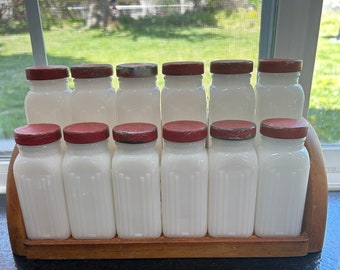 White milk glass Griffith Laboratories red capped twelve spice bottles on wooden rack circa 1940s. No chips and in real nice condition!!