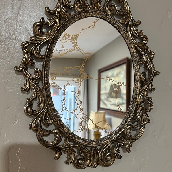 Vintage cast filigree antiqued brass oval frame with mirror. Beautiful for the hallway, bathroom,bedroom.