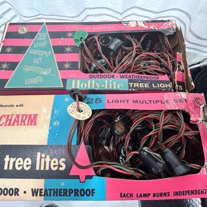May include: Two boxes of 25-light outdoor Christmas tree lights. The boxes are red, white, and blue with a Christmas tree design. The text on the boxes reads "Holly-lite Tree Lights", "Outdoor Weatherproof", "25 Light Multiple Set", "Charm", "Tree Lites", and "Each Lamp Burns Independently".