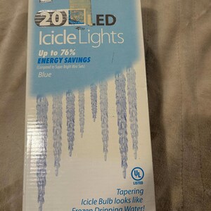May include: A box of 20 blue LED icicle lights. The box features a picture of the lights and the text "Up to 76% ENERGY SAVINGS (Compared to Super Bright Mini Sets)". The box also has a UL Listed label.