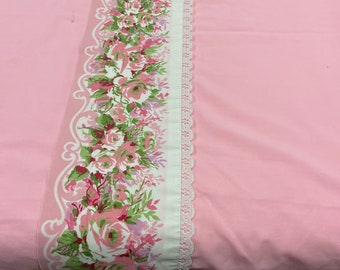 Pink queen sized bed flat sheet by Cannon Royal Family with a beautiful rose floral border at top of sheet