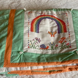 Small childs handmade quilt with embroidery of cross stitched squares. Could be repurposed for new childs quilt with embroidered blocks!