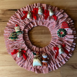 Wreath Handmade pleated candy cane striped fabric Christmas wreath from the 1970s. Beautiful hanging in kitchen window!