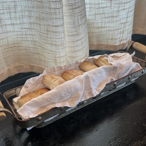 Old bread basket of metal with wooden handles. Great for serving your favorite artisan breads/buns/rolls. Guessing circa 1960s era.