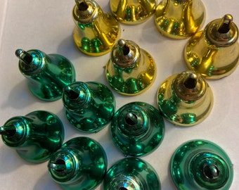 May include: A collection of 12 Christmas bells, 6 are green and 6 are gold. The bells are shiny and have a metallic finish.