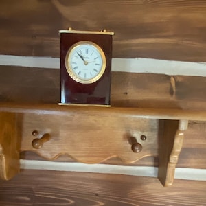 Shelf Vintage wooden shelf with pegs for hanging something on. Has a plate groove. Pretty in a camp/cabin or home! Christmas elf shelf
