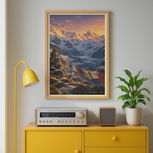 May include: A framed wall art print depicting a snow-covered mountain range at sunset with a stone cairn and colorful prayer flags in the foreground. The text "ANNAPURNA - 8,091M" is printed in the bottom right corner of the mountain landscape image.