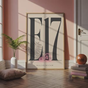 May include: A rectangular wall art print in a wooden frame featuring the large black text E17 on a cream background. A small pink neon-style light bulb graphic is positioned over the number 7, with the word WALTHAMSTOW printed in small black letters below.
