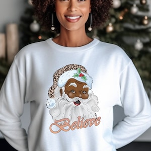 Black santa believe sweater sales