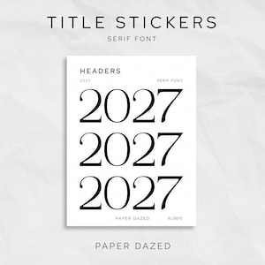 May include: A white rectangular sheet of title stickers featuring the text TITLE STICKERS, HEADERS, 2027, SERIF FONT, PAPER DAZED, and XL-2027C. The sheet displays three instances of the year 2027 in a large black serif font on a white background.