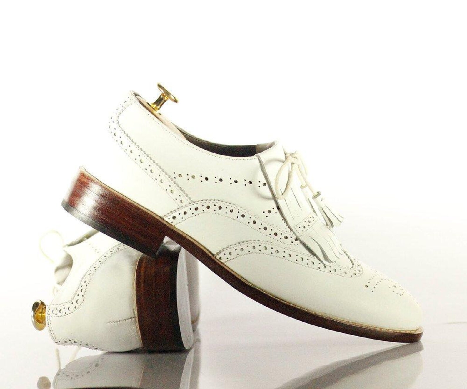 grey and white wingtip shoes