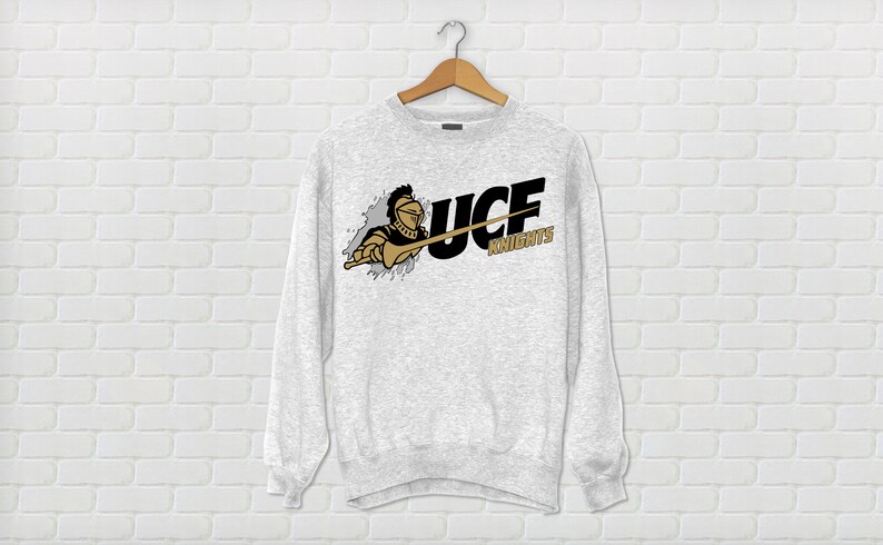 May include: A gray sweatshirt with a black and gold UCF Knights logo. The logo features a knight holding a sword and the words "UCF Knights".
