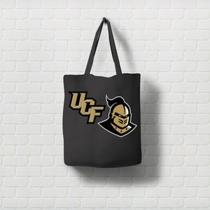 May include: Black canvas tote bag with a gold UCF logo and a knight's head graphic.