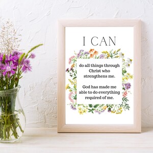 May include: A framed print with a white background and a floral border. The text "I CAN" is in large black letters at the top of the print. The text "do all things through Christ who strengthens me. God has made me able to do everything required of me." is in smaller black letters below the floral border.