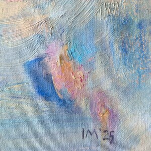 May include: Abstract oil painting with visible brushstrokes. The artwork features a blend of blues, pinks, and creams. The artist's initials "IM" and the year "23" are signed in the lower right corner. The painting has a textured appearance.