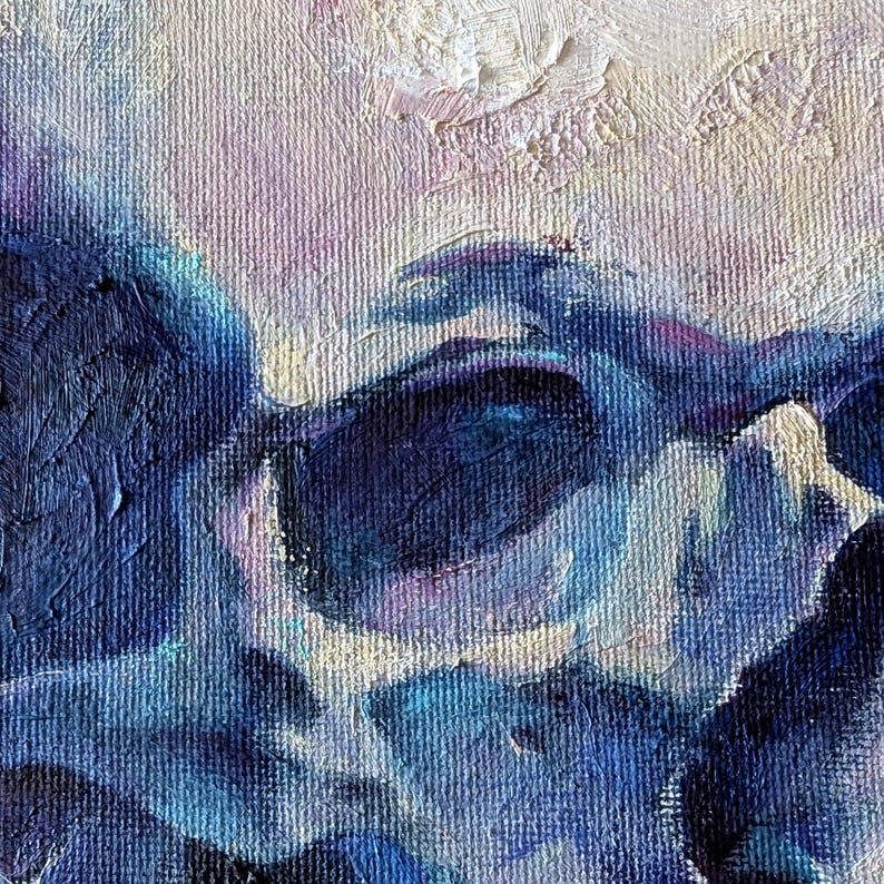 May include: Close-up of an abstract painting with textured brushstrokes. The artwork features a blend of deep blues, purples, and hints of white and pink. The canvas has a visible weave, adding depth to the piece. The style is reminiscent of impressionism.