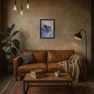 May include: A living room scene featuring a brown leather sofa, a wooden coffee table, and a framed abstract art piece. A floor lamp and a potted plant add to the decor. The artwork depicts a skull in shades of blue and purple.
